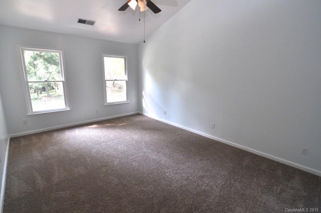 5015 Ridgetop Trail Charlotte, NC 28215 - Photo 16 of 24 an empty room with windows and fan
