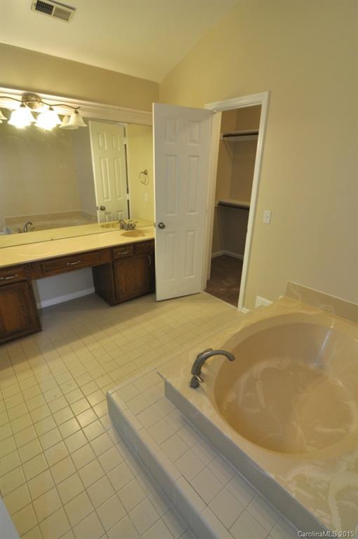 5015 Ridgetop Trail Charlotte, NC 28215 - Photo 17 of 24 a bathroom with a tub and a sink