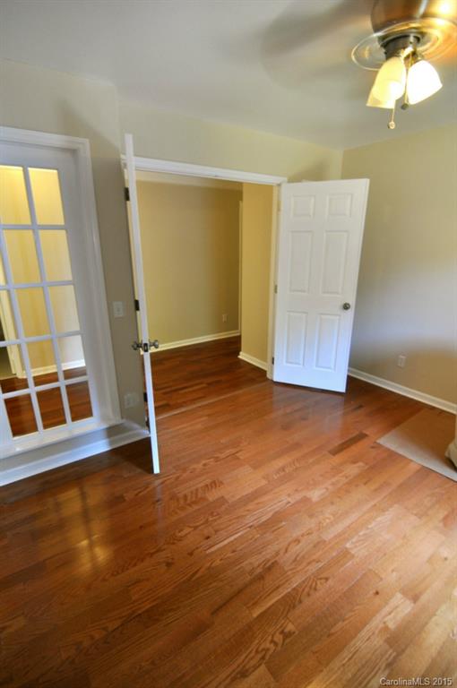 5015 Ridgetop Trail Charlotte, NC 28215 - Photo 18 of 24 an empty room with wooden floor and windows
