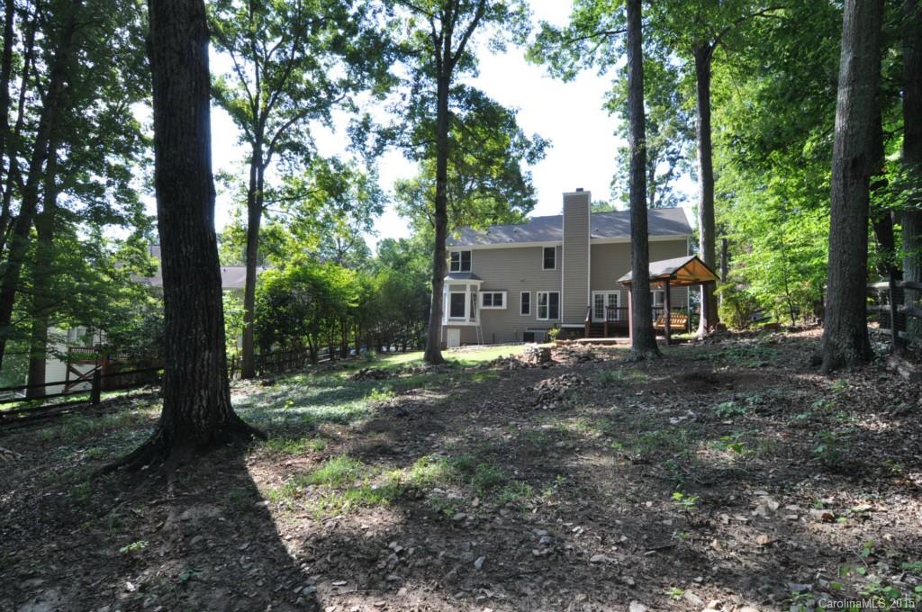 5015 Ridgetop Trail Charlotte, NC 28215 - Photo 3 of 24 a view of a house with a tree in the forest