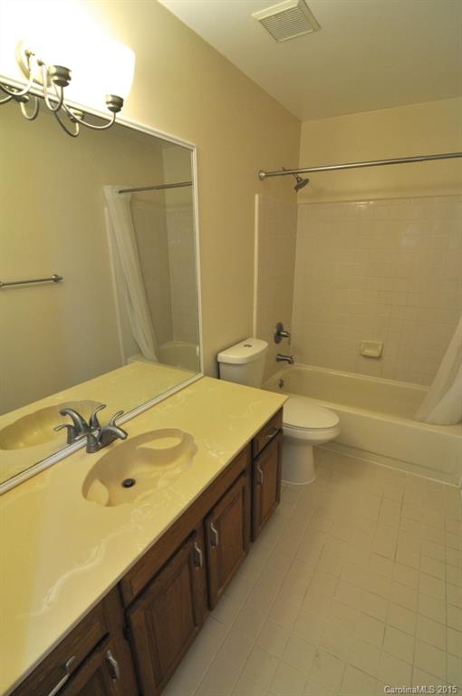 5015 Ridgetop Trail Charlotte, NC 28215 - Photo 21 of 24 a bathroom with a sink a toilet and shower