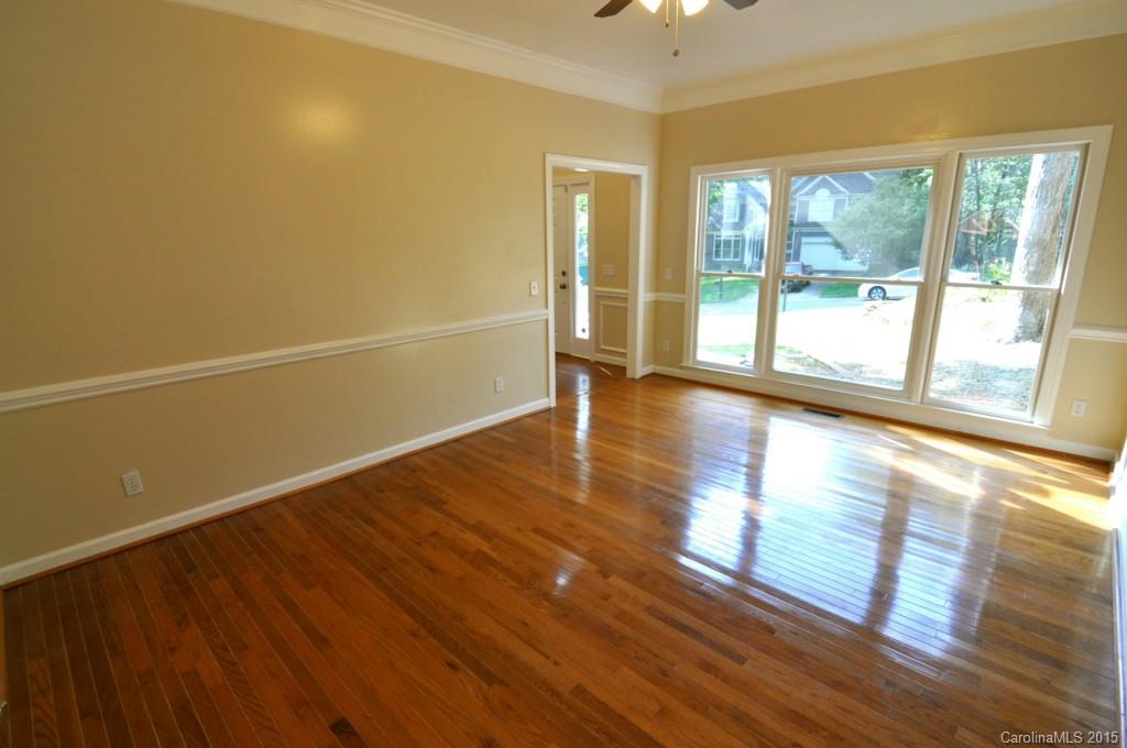 5015 Ridgetop Trail Charlotte, NC 28215 - Photo 7 of 24 a view of an empty room with wooden floor and a window