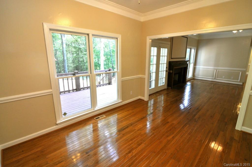 5015 Ridgetop Trail Charlotte, NC 28215 - Photo 8 of 24 a view of empty room with wooden floor and fan