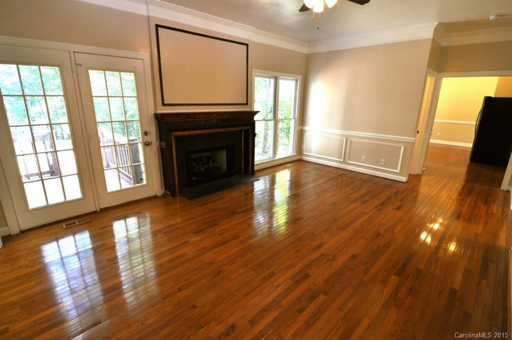 5015 Ridgetop Trail Charlotte, NC 28215 - Photo 9 of 24 a view of empty room with wooden floor and fireplace