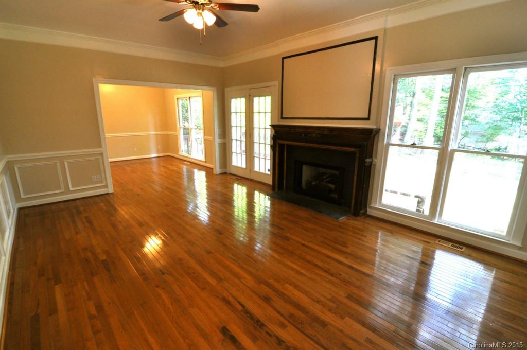 5015 Ridgetop Trail Charlotte, NC 28215 - Photo 10 of 24 a view of an empty room with wooden floor and a window
