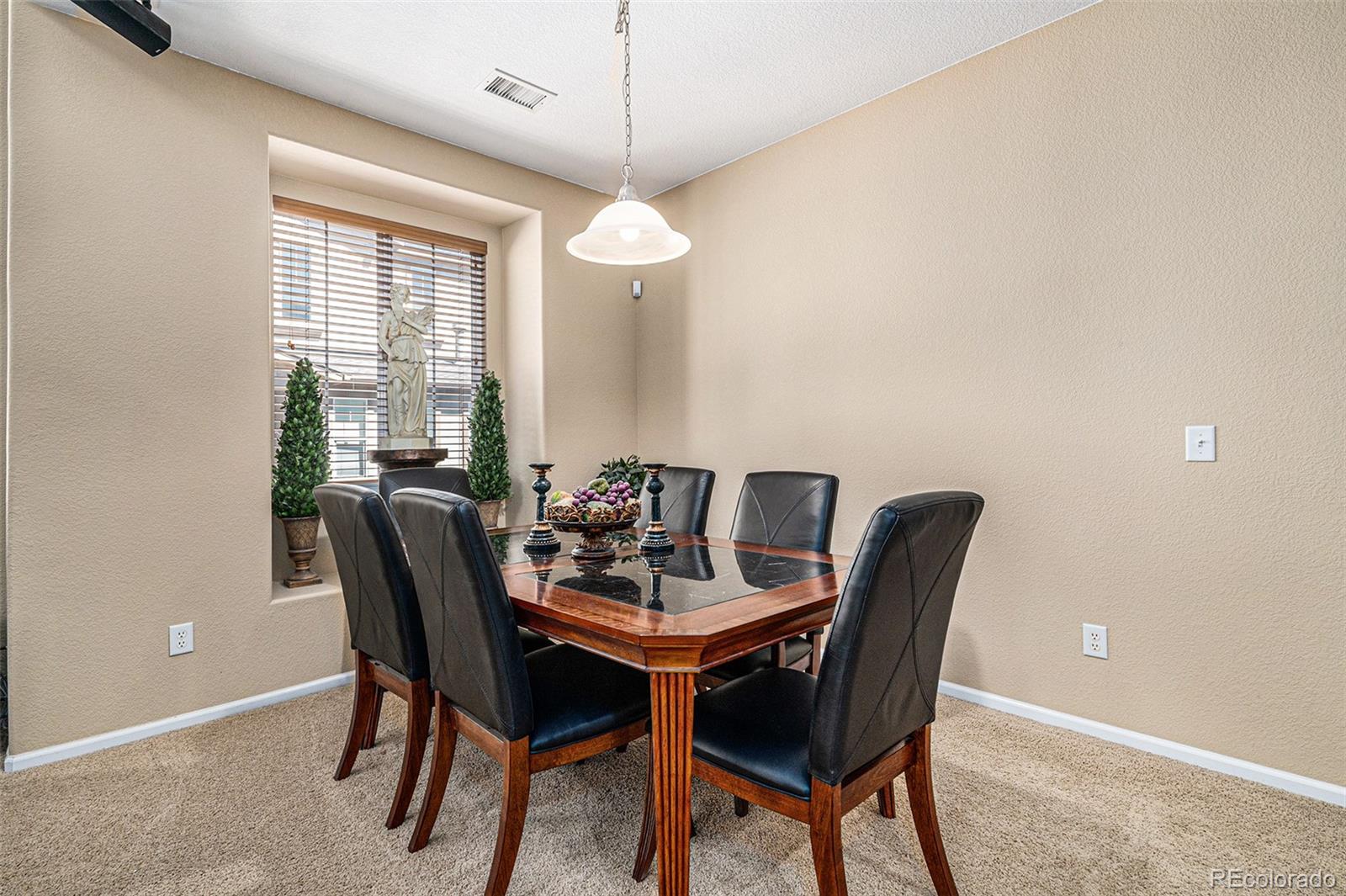 10515 Ashfield Street, Unit 1D Highlands Ranch, CO 80126 - Photo 15 of 39 a view of a dining room with furniture and window