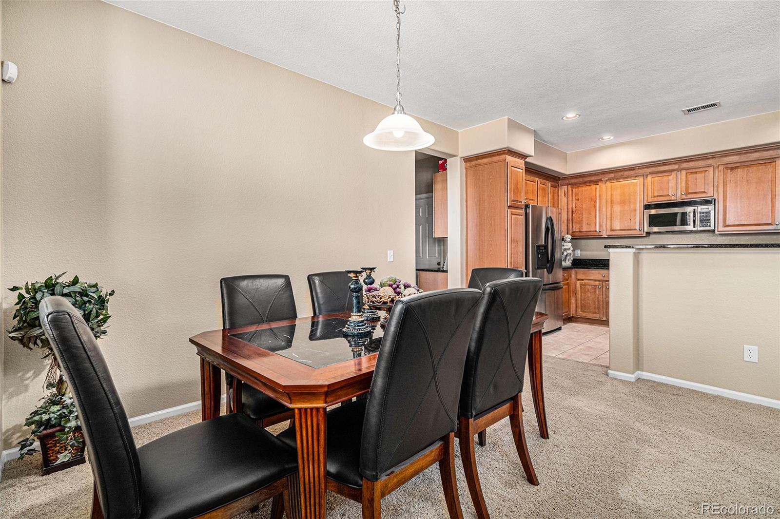 10515 Ashfield Street, Unit 1D Highlands Ranch, CO 80126 - Photo 16 of 39 a view of a dining room with furniture