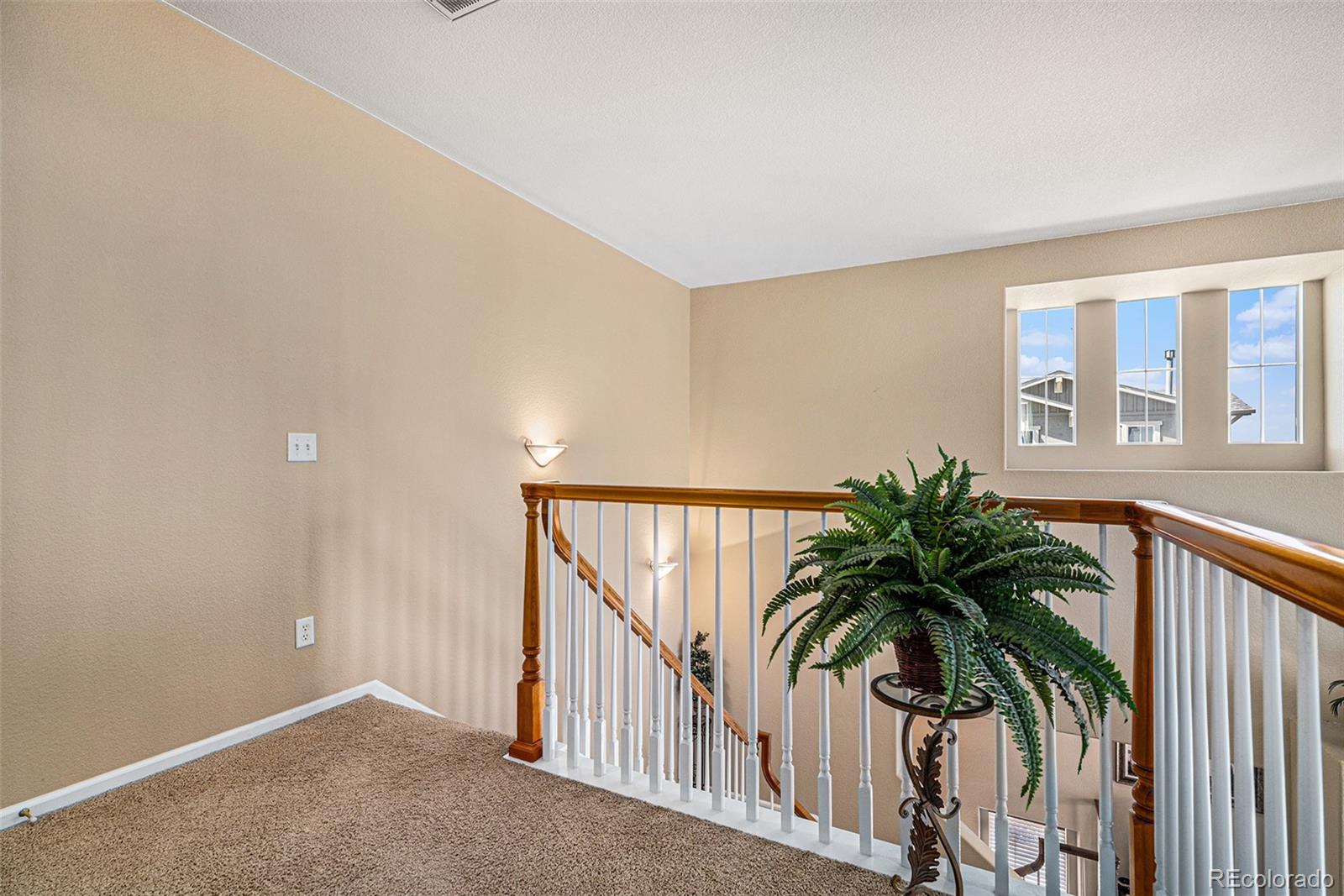 10515 Ashfield Street, Unit 1D Highlands Ranch, CO 80126 - Photo 28 of 39 a view of entryway with wooden floor and stairs