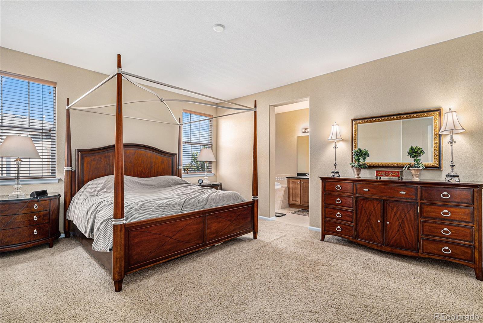 10515 Ashfield Street, Unit 1D Highlands Ranch, CO 80126 - Photo 29 of 39 a bedroom with a bed dresser and a sink