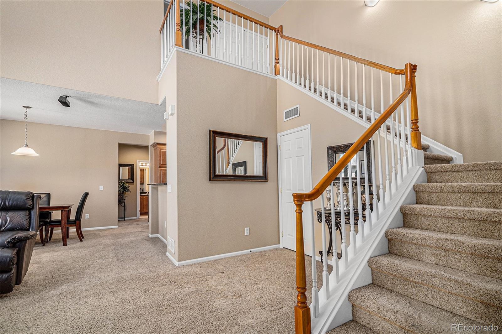 10515 Ashfield Street, Unit 1D Highlands Ranch, CO 80126 - Photo 6 of 39 a view of staircase with lots of frames and couches