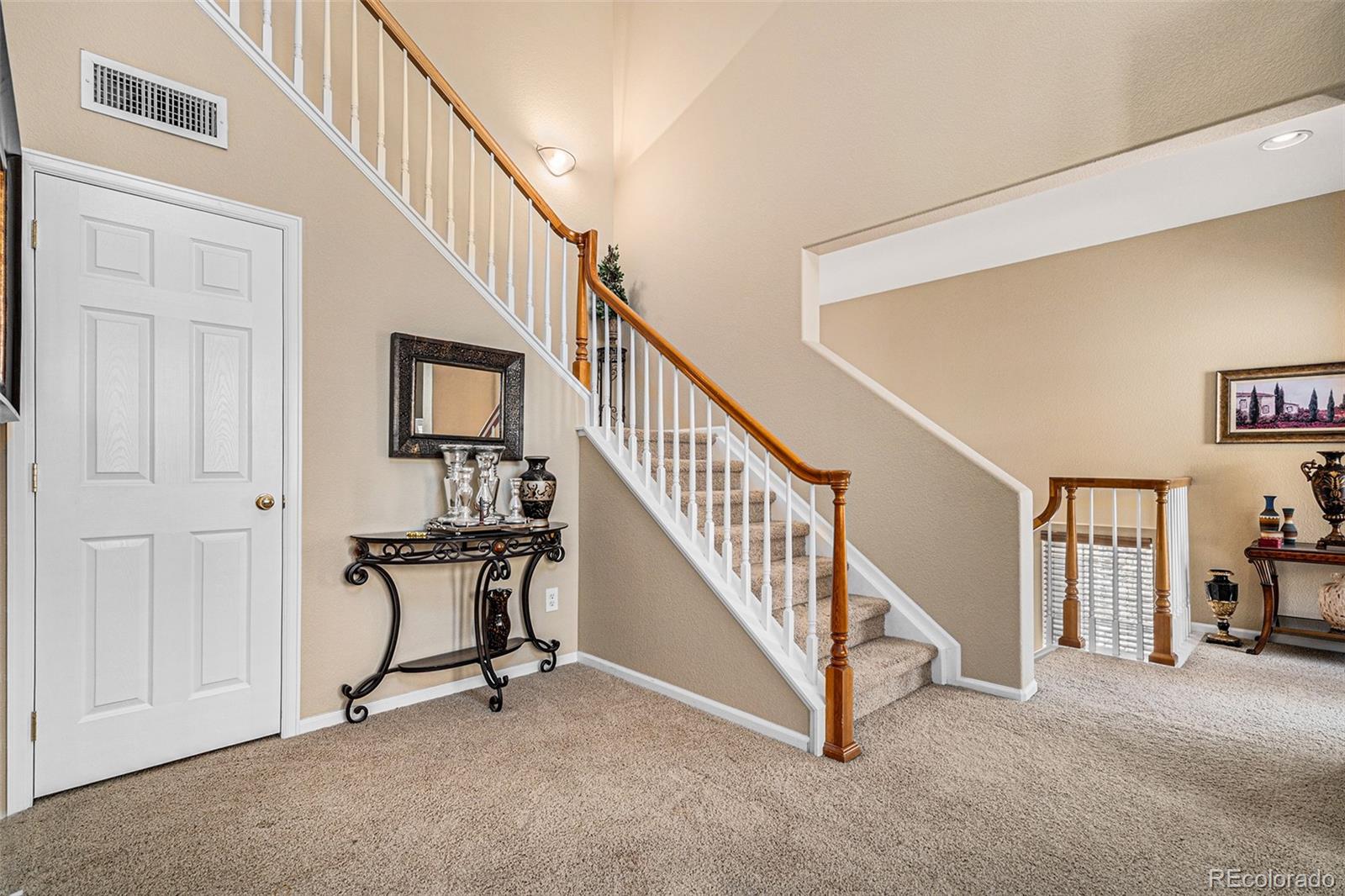 10515 Ashfield Street, Unit 1D Highlands Ranch, CO 80126 - Photo 8 of 39 a view of a livingroom with furniture and staircase