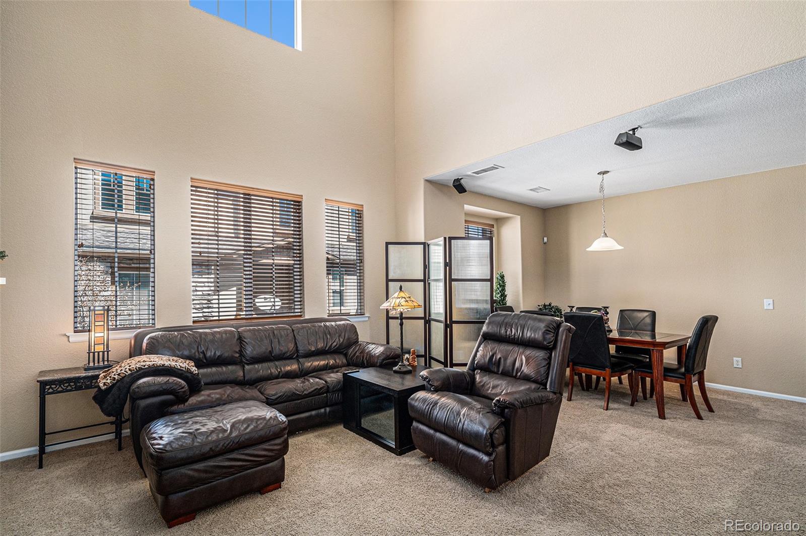 10515 Ashfield Street, Unit 1D Highlands Ranch, CO 80126 - Photo 10 of 39 a living room with furniture and a large window
