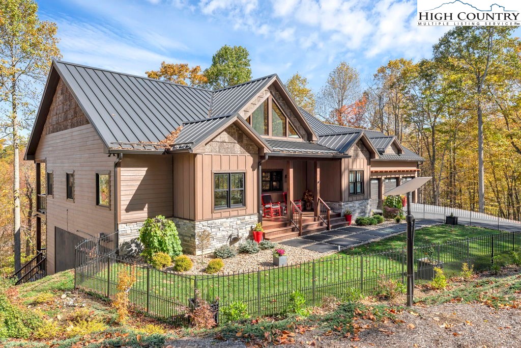 322 South Creek Drive Boone, NC 28607 - Photo 2 of 50 a front view of a house with swimming pool and chairs