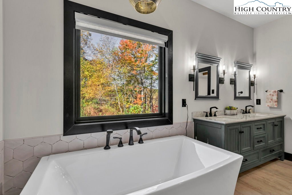322 South Creek Drive Boone, NC 28607 - Photo 26 of 50 a bathroom with a tub sink and mirror