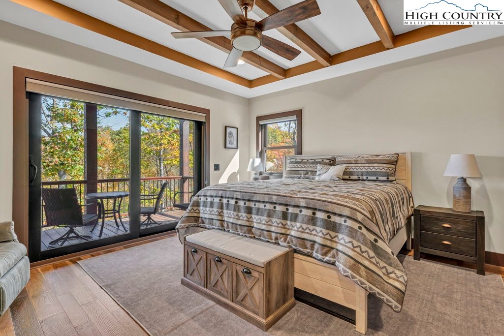322 South Creek Drive Boone, NC 28607 - Photo 29 of 50 a bedroom with a bed a window and a chandelier