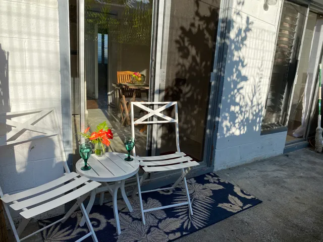 a backyard of a house with table and chairs