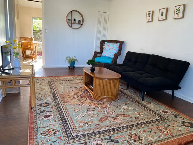a living room with a rug and a rug