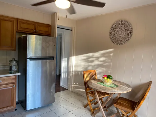 a kitchen with stainless steel appliances granite countertop a refrigerator a sink a stove and island