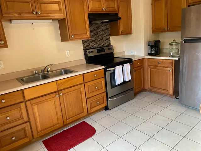 a kitchen with stainless steel appliances granite countertop a sink stove and cabinets