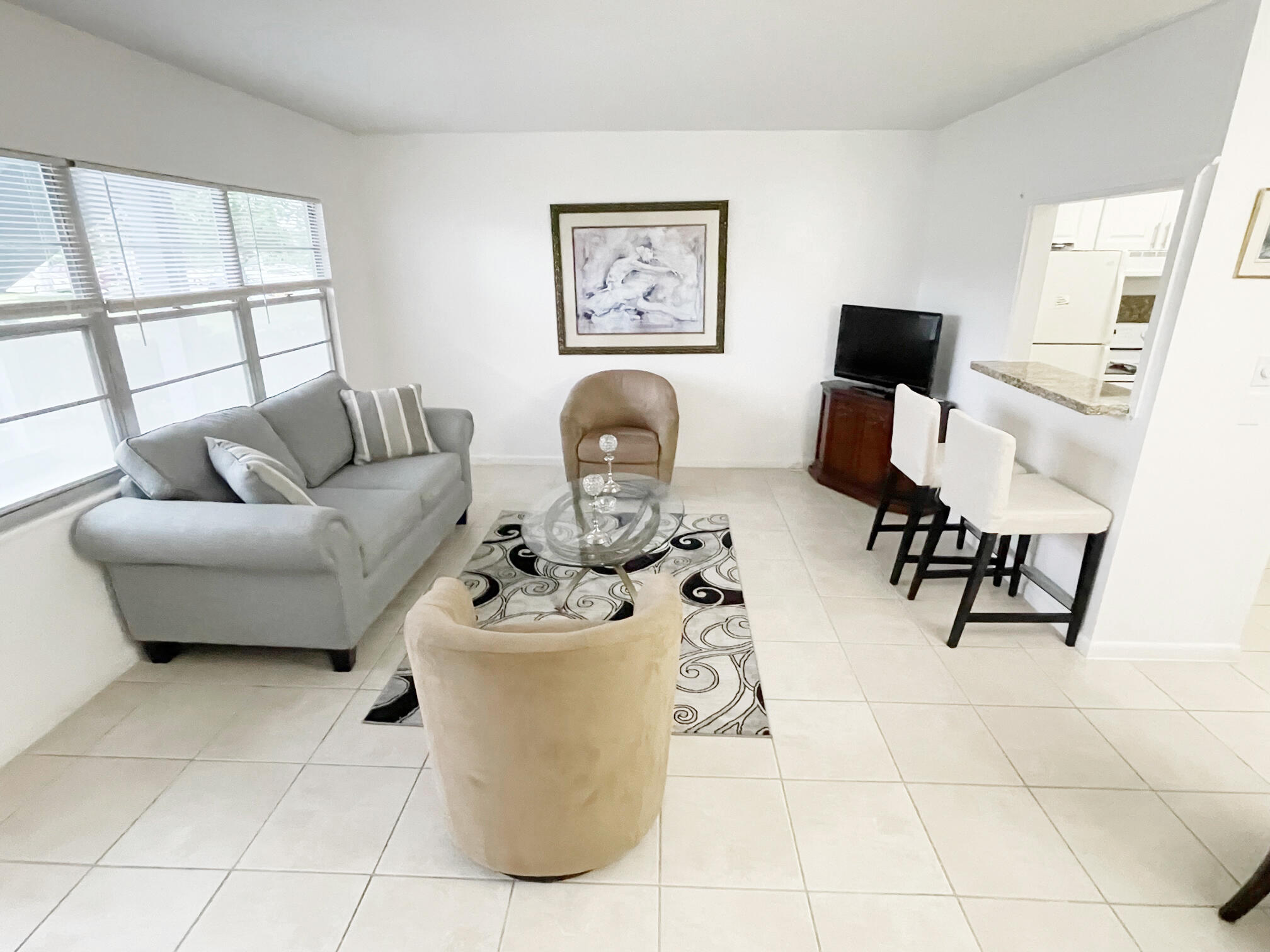 171 Suffolk F, Unit 171 Boca Raton, FL 33434 - Photo 6 of 21 a living room with furniture and a window