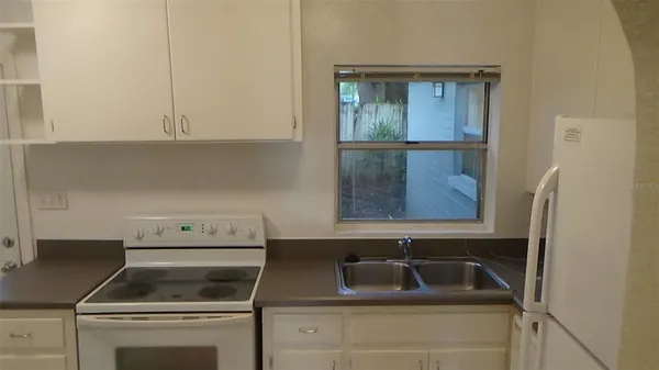 a kitchen with a sink and a stove top oven