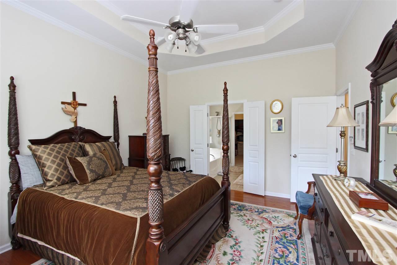 3402 Ranbir Drive Durham, NC 27713 - Photo 12 of 24 a bed room with a bed and a chandelier