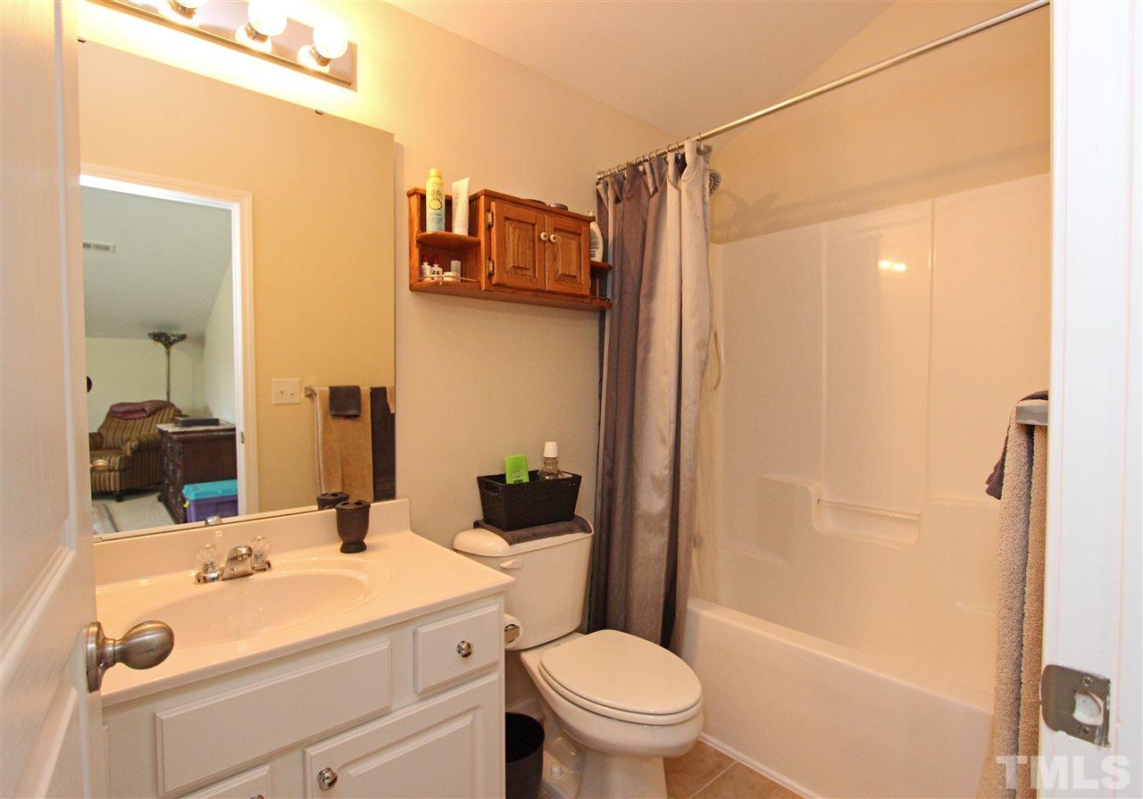 3402 Ranbir Drive Durham, NC 27713 - Photo 18 of 24 a bathroom with a sink a toilet and shower
