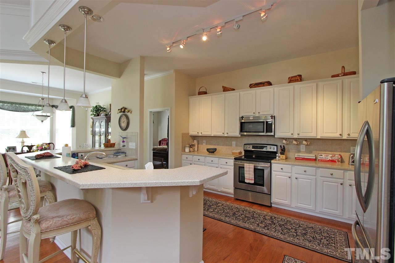 3402 Ranbir Drive Durham, NC 27713 - Photo 4 of 24 a kitchen with a stove a sink a refrigerator and cabinets