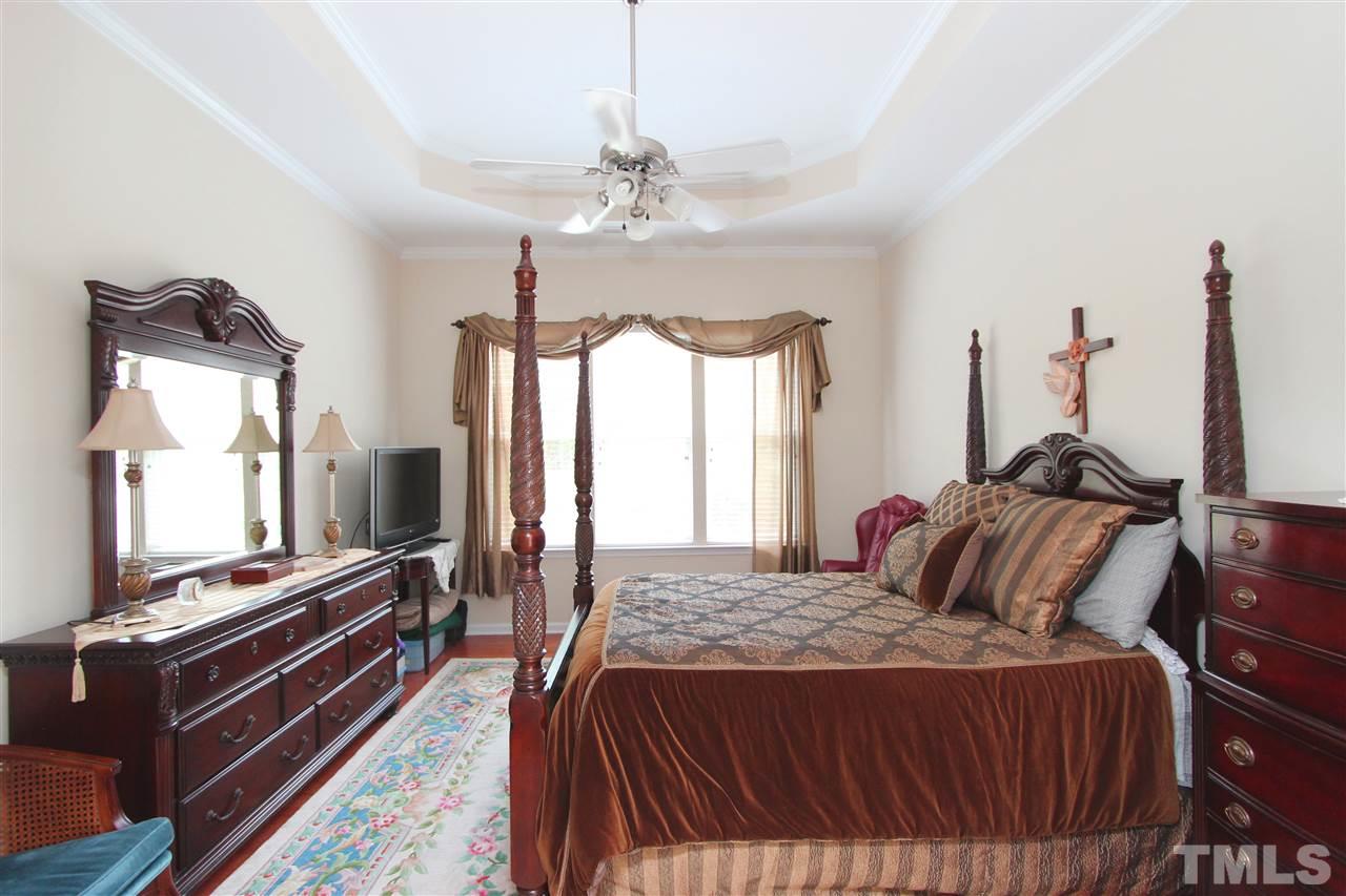 3402 Ranbir Drive Durham, NC 27713 - Photo 10 of 24 a bedroom with a bed and a flat screen tv