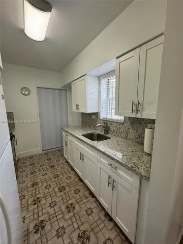 a kitchen with a sink and cabinets
