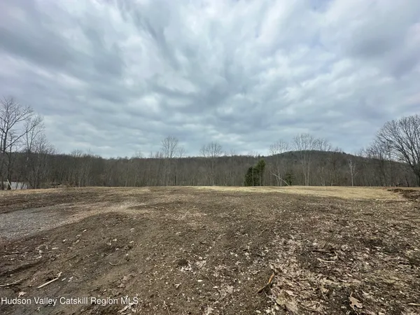 a view of a field with wooden fence