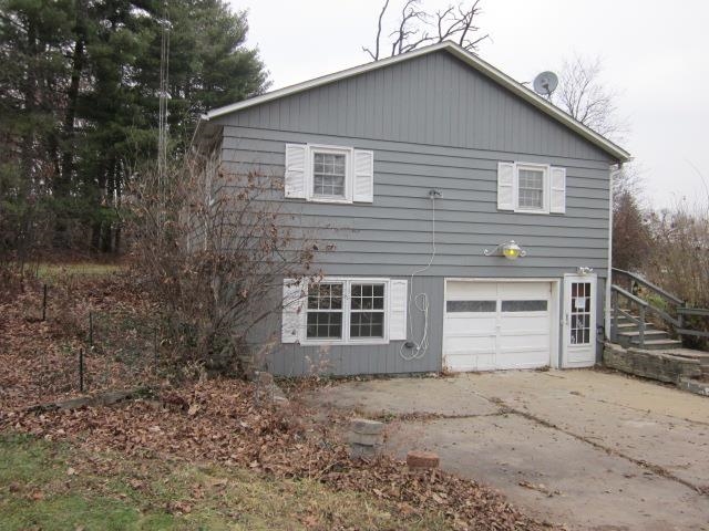 8141 Us Rte 20 West Lena, IL 61048 - Photo 2 of 22 a front view of a house with a yard and garage