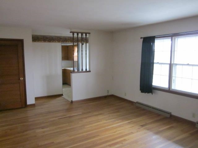8141 Us Rte 20 West Lena, IL 61048 - Photo 9 of 22 an empty room with wooden floor and windows