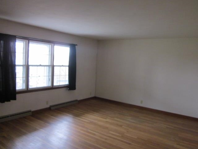 8141 Us Rte 20 West Lena, IL 61048 - Photo 10 of 22 a view of an empty room with wooden floor and a window