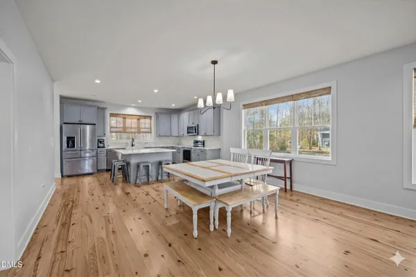 a en suite bathroom with a granite countertop sink and a mirror