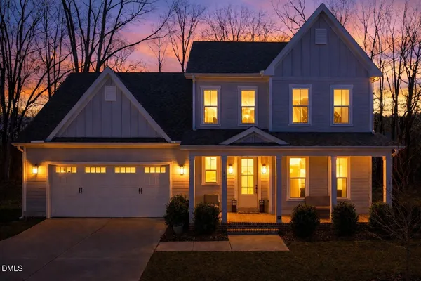 a kitchen with stainless steel appliances granite countertop a stove top oven a sink dishwasher a dining table and chairs with wooden floor