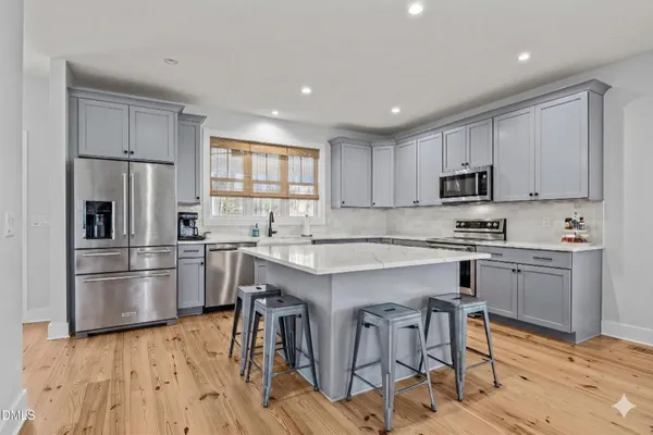 a stove top oven sitting inside of a kitchen