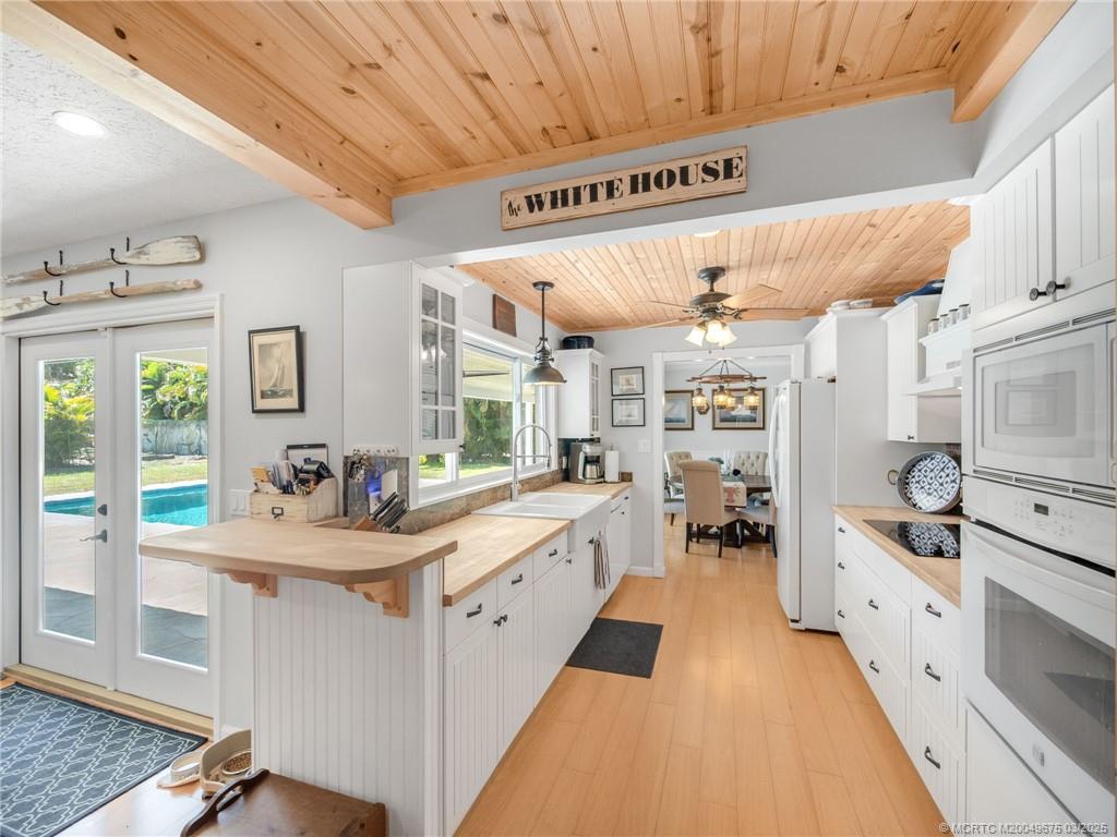 1318 Southeast Riverside Drive Stuart, FL 34996 - Photo 11 of 29 a kitchen with sink cabinets and window
