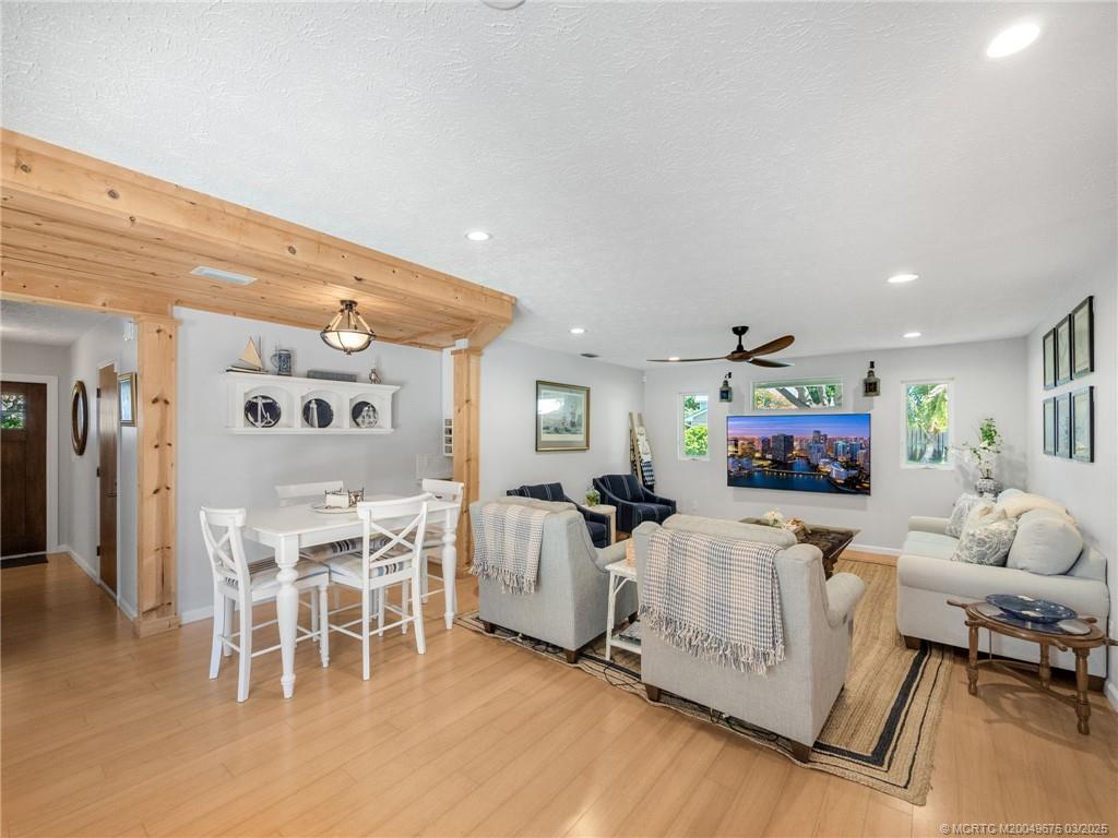 1318 Southeast Riverside Drive Stuart, FL 34996 - Photo 13 of 29 a living room with furniture a fireplace and a flat screen tv