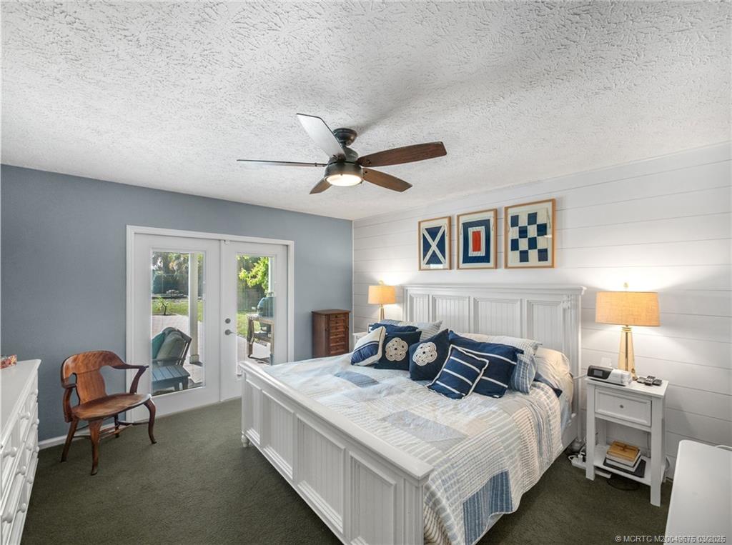 1318 Southeast Riverside Drive Stuart, FL 34996 - Photo 15 of 29 a bed room with a bed and a chair