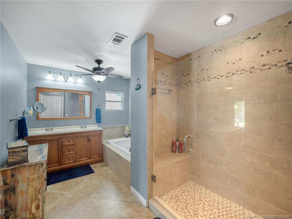 1318 Southeast Riverside Drive Stuart, FL 34996 - Photo 17 of 29 a spacious bathroom with a granite countertop sink a toilet a mirror and shower