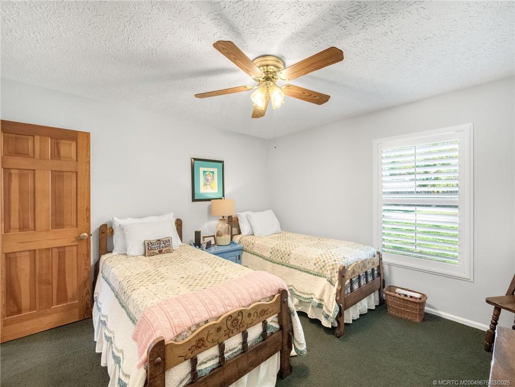 1318 Southeast Riverside Drive Stuart, FL 34996 - Photo 21 of 29 a bedroom with two beds and a window