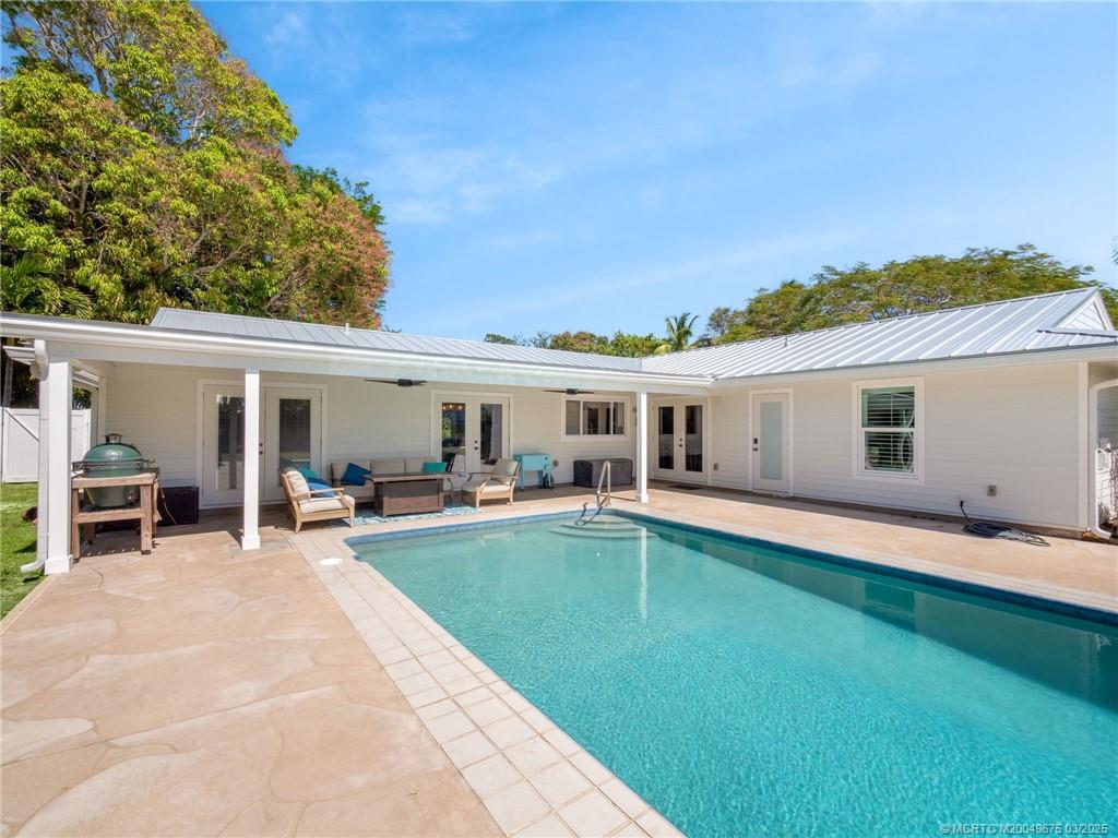1318 Southeast Riverside Drive Stuart, FL 34996 - Photo 25 of 29 a view of a house with swimming pool and porch with furniture
