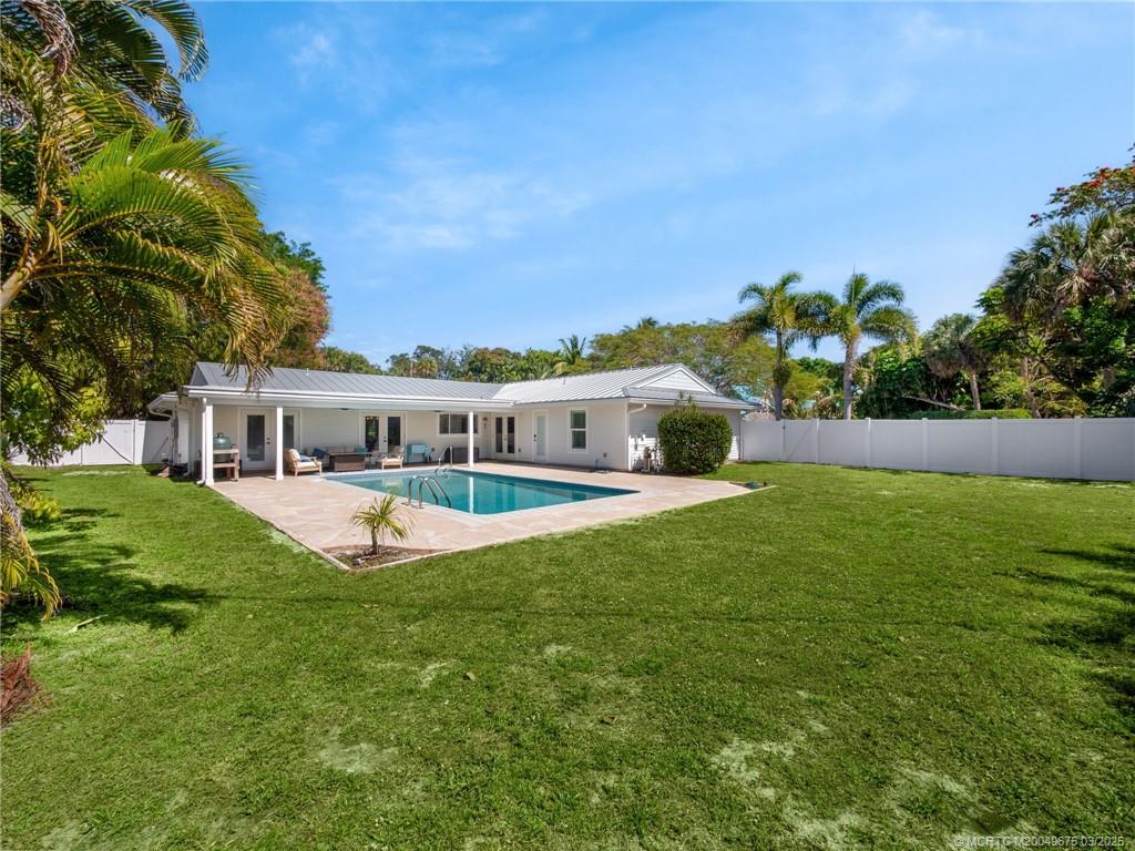 1318 Southeast Riverside Drive Stuart, FL 34996 - Photo 27 of 29 a front view of a house with a garden