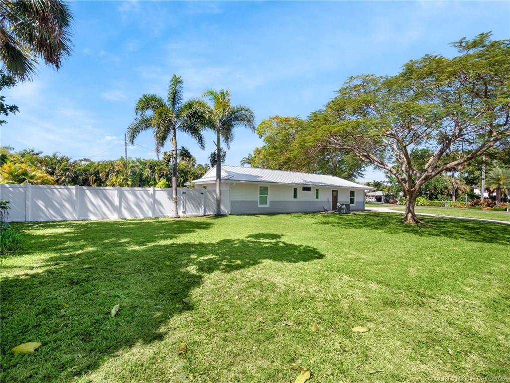 1318 Southeast Riverside Drive Stuart, FL 34996 - Photo 29 of 29 a front view of a house with a yard and tree