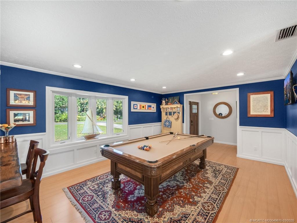 1318 Southeast Riverside Drive Stuart, FL 34996 - Photo 6 of 29 a living room with large window and a table