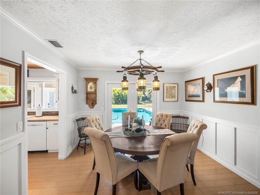 1318 Southeast Riverside Drive Stuart, FL 34996 - Photo 8 of 29 a view of a dining room with furniture window and wooden floor