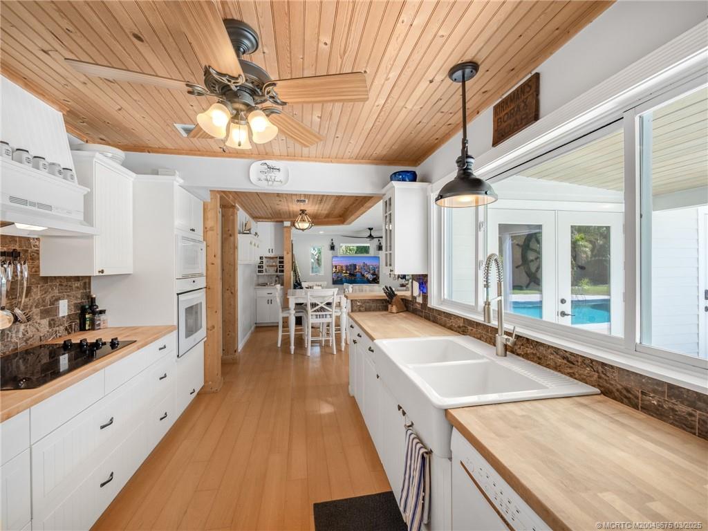 1318 Southeast Riverside Drive Stuart, FL 34996 - Photo 9 of 29 a large white kitchen with a large window