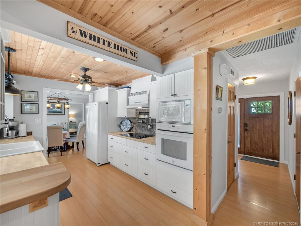 1318 Southeast Riverside Drive Stuart, FL 34996 - Photo 10 of 29 a hallway with cabinets and wooden floor