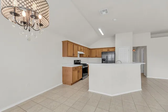 a kitchen with stainless steel appliances a refrigerator and a stove